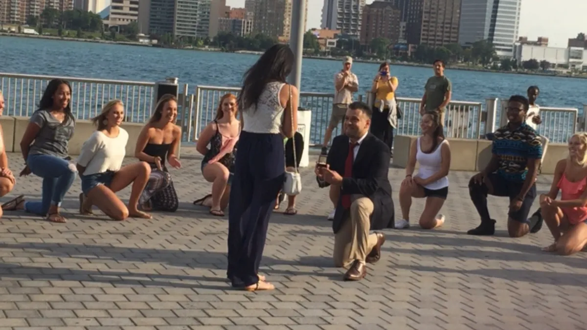 Dancers performing a surprise flash mob marriage proposal