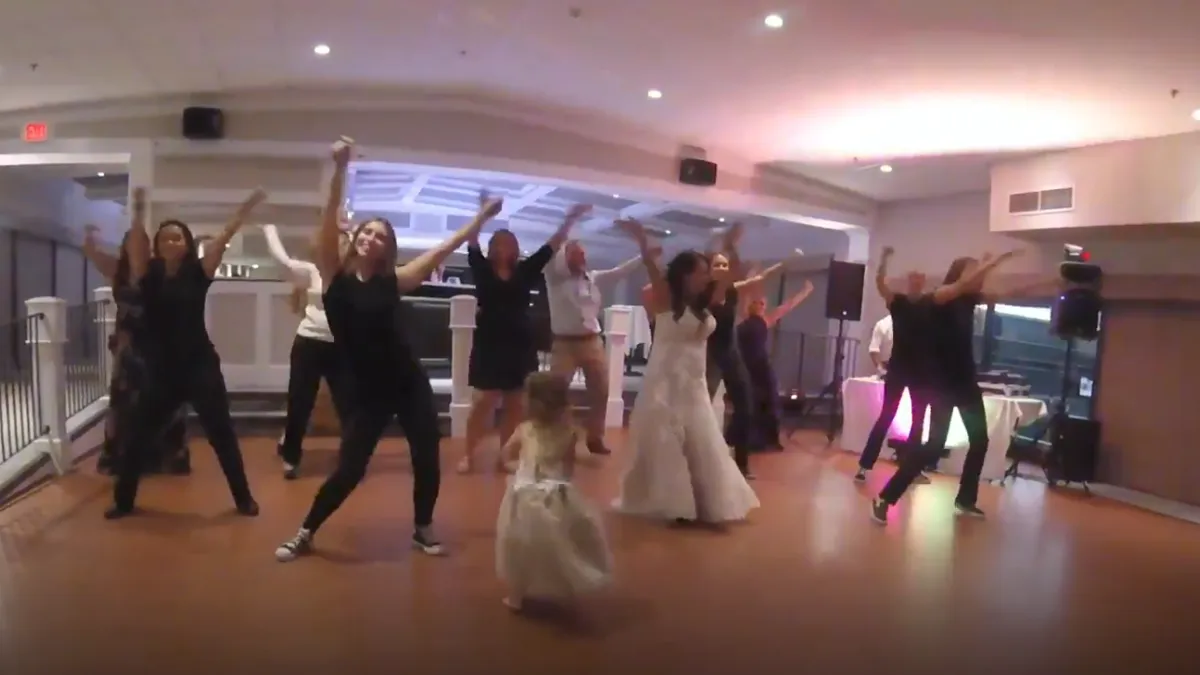 Dancers performing a surprise wedding flash mob at a reception