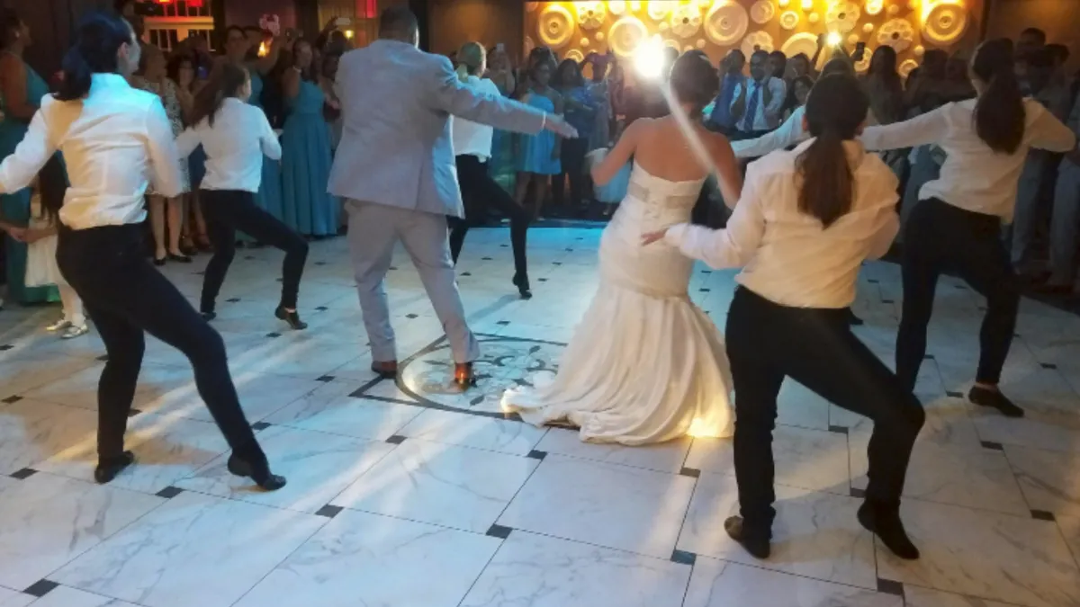 Wedding party joining a surprise flash mob on the dance floor