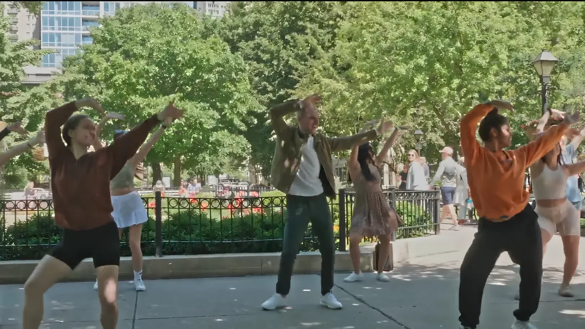 Dancers performing a choreographed flash mob routine at an event